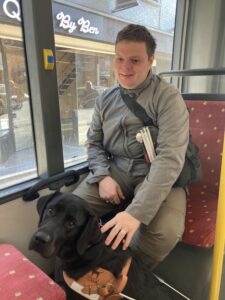 Telma assise entre les jambe de son bénéficiaire dans le bus